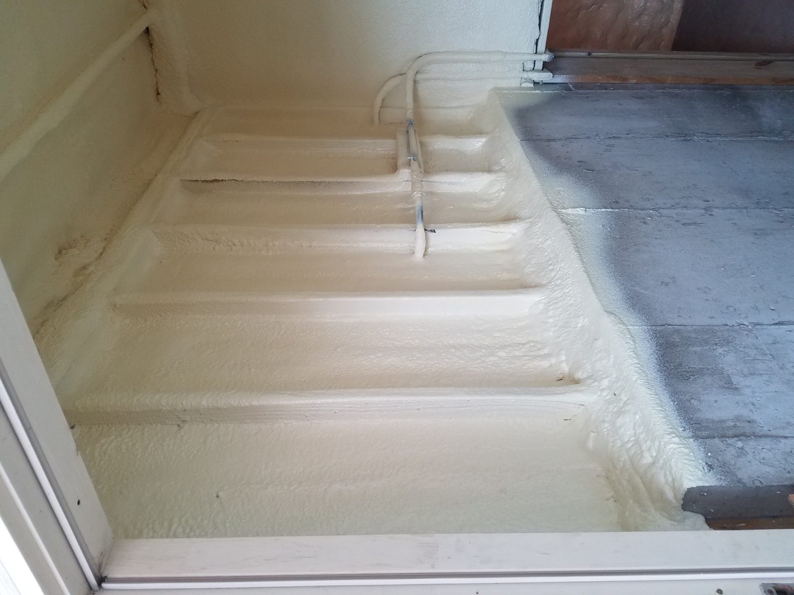Wall cavity spray foam insulation